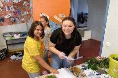 Lehrerin hilft Kind beim basteln